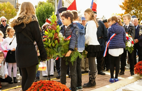 Dépot de gerbes par les enfants de l'école au Monument aux morts 